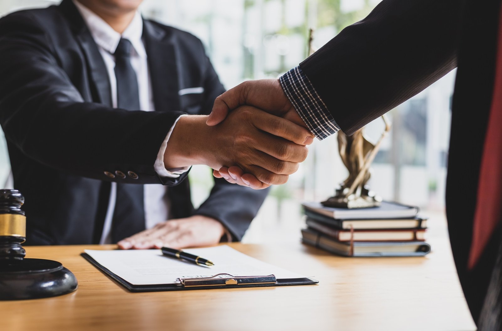 Legal service agreement of business men doing a handshake