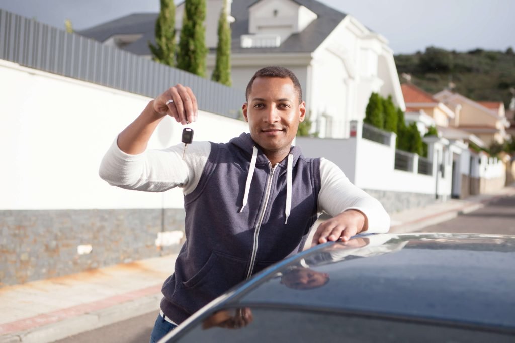 Man lifting up a car key